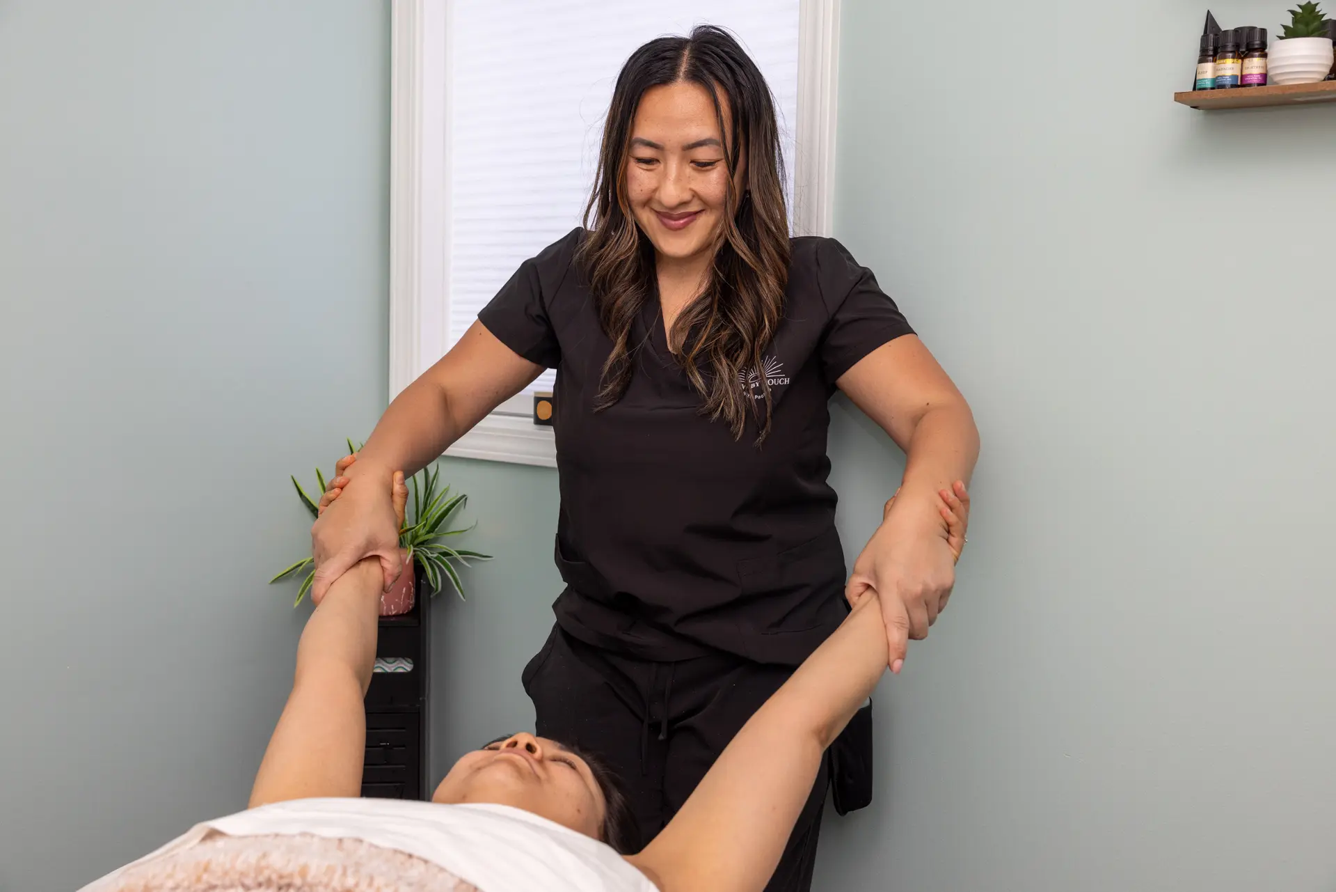 Assisted stretching during a table Thai massage