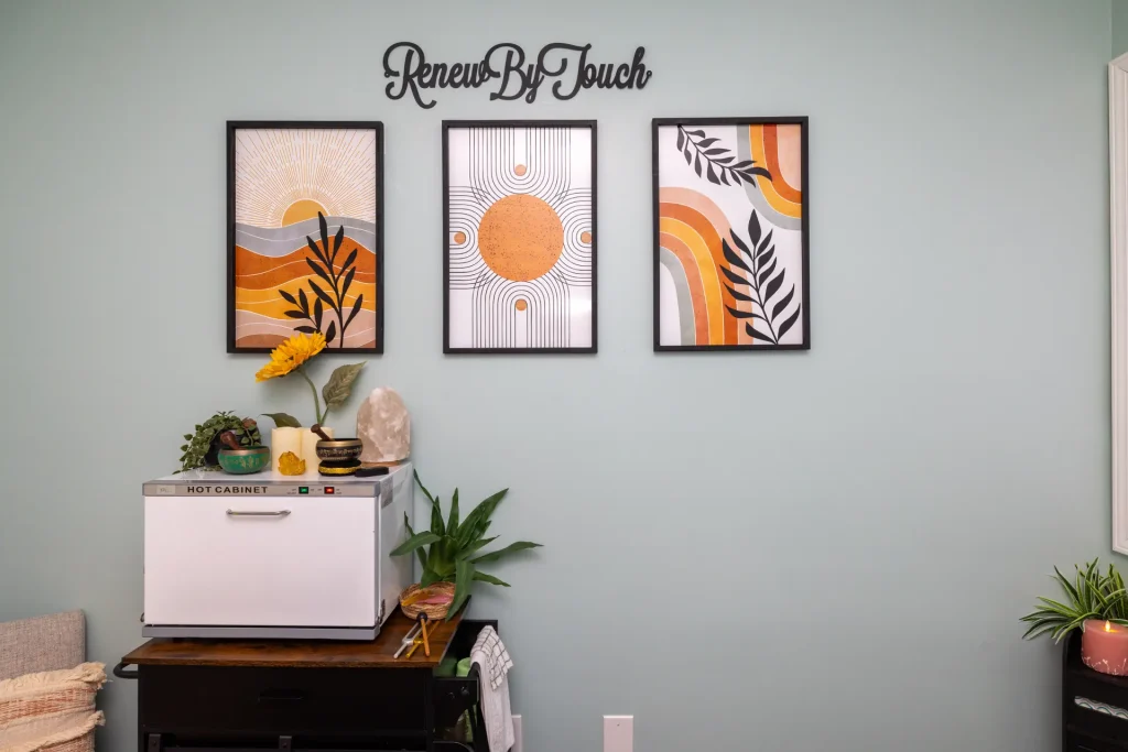 Renew By Touch treatment room with warm art and soft lighting